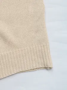 Detail of ribbed hem and knit texture on this cream casual loose cardigan sweater