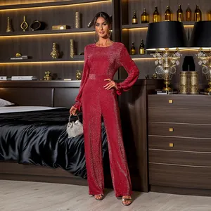 Detail of red sequin jumpsuit featuring elegant ruffled cuffs and sparkling metallic fabric