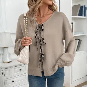 Detail of khaki V-neck knit cardigan with leopard print bow and ribbed texture finish