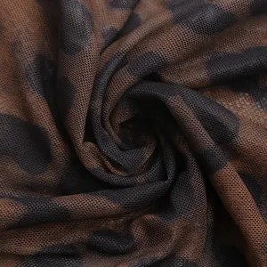 Close-up of lightweight leopard print mesh fabric with breathable semi-transparent texture