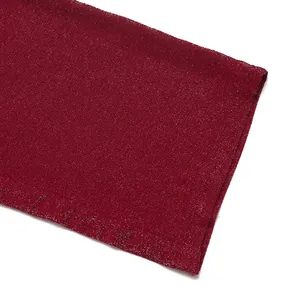 Detail shot of the sequined dark red fabric texture on high waist jumpsuit sleeves