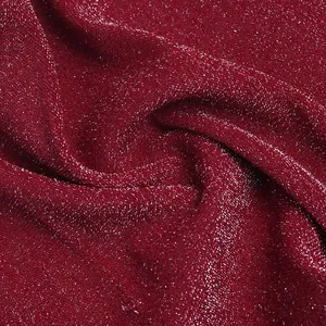 Macro detail of wine red sequin fabric with sparkling silver metallic thread texture