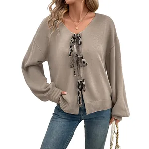 Beige V-neck cardigan with leopard print bow ties and oversized knit design