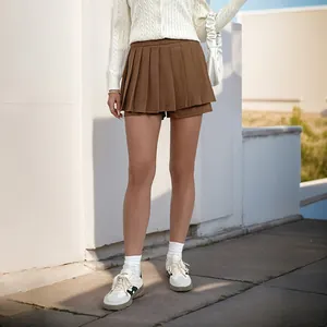 Detail view of brown pleated high waist mini skirt showing textured fabric and layering