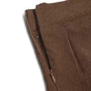 Close-up of side invisible zipper on dark brown corduroy pleated mini skirt