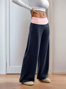 Detail of color-block wide-leg trousers with pink waistband and grey fabric