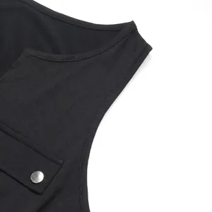 Detail view of black sleeveless romper with V-neck, metal button pocket and neat stitching