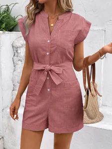 Detail of pink pinstripe romper featuring front pockets and waist tie for summer style