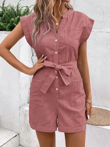 Detail of pink striped romper showing button placket, waist tie, and pocket details