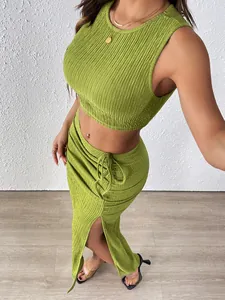 Detail of green ruched texture fabric with side drawstring and high slit on a long skirt