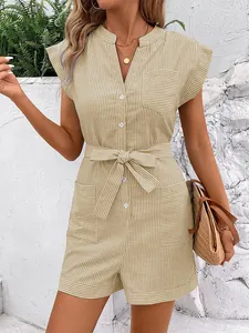 Detail of yellow pinstripe romper with button-down front, belted waist and side pockets