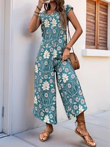 Detail of bohemian summer wide-leg jumpsuit featuring leaf and daisy floral print