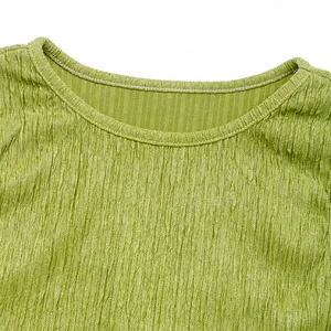 Detail of green ruched fabric texture with round neckline and fine stitching