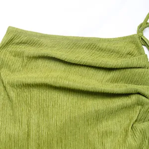 Detailed macro view of green crinkled fabric texture with drawstring waist detail