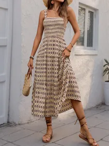 Detail of bohemian smocked bodice and geometric print on summer spaghetti strap dress