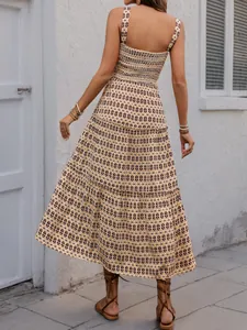 Detail of bohemian smocked bodice and tiered floral skirt on a summer sun dress