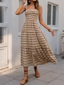 Detail of smocked bodice and tiered hem on a bohemian floral print maxi summer dress