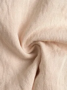 Detailed macro view of soft textured apricot fabric layers on summer ruffle shorts