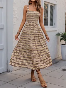 Detailed view of bohemian tiered maxi dress with smocked bodice and geometric print