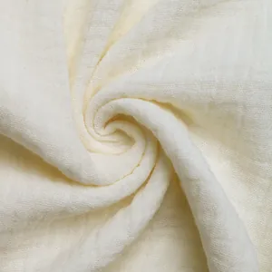 Close-up of textured off-white cotton fabric with breathable muslin crepe pattern
