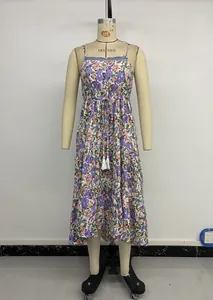 Detailed view of floral sun dress featuring ruffled tiers, drawstring waist and white tassels