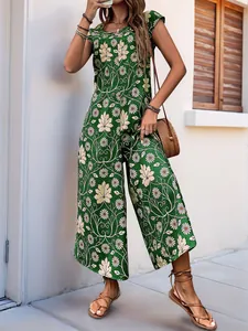 Detail of green floral wide-leg jumpsuit with daisy print and casual sleeveless design