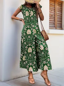 Detail view of sleeveless green jumpsuit with daisy and leaf prints for summer vacation