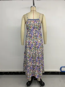 Detail of floral spaghetti strap maxi dress featuring tiered ruffle layers and ribbon trim