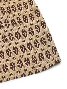 Detail of summer dress featuring retro geometric diamond pattern and stitched hemline