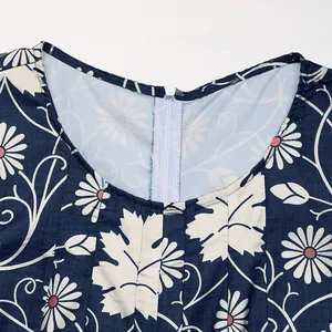 Close-up of crew neck with back zipper and floral print on navy wide-leg jumpsuit