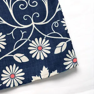 Detail of navy blue fabric with white daisy floral pattern and leaf vine prints