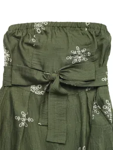 Detail of olive green linen jumpsuit with white embroidery and waist bow tie