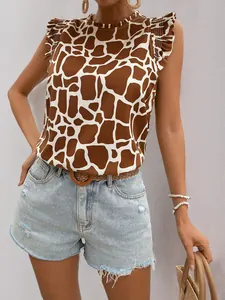 Detail of giraffe print ruffled sleeveless top tucked into denim shorts with woven belt