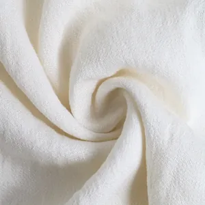 Close-up of white high-quality knit fabric texture showing soft breathable fibers