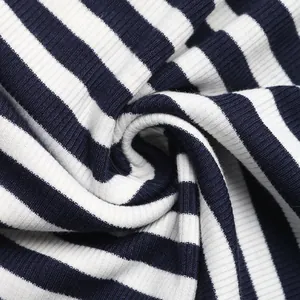 Macro detail of navy blue and white striped ribbed knit fabric with soft texture