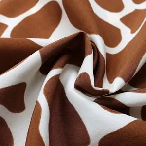 Close-up of giraffe print fabric showing soft texture and detailed animal pattern