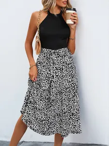 Detail of high waist leopard print midi skirt with waist tie and black knit halter top