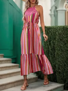 Close-up of pink crochet lace detailing on colorful striped halter neck maxi dress