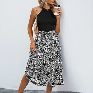 Sleeveless halter neck dress with black top and leopard print midi skirt and waist tie