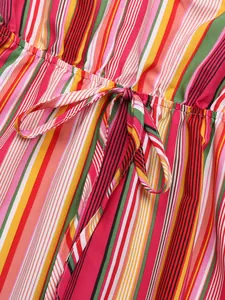 Detail of colorful vertical striped dress featuring elastic waist and matching drawstring tie