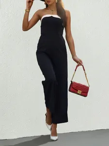 Detail of a chic black and white strapless jumpsuit with flowing wide-leg trousers