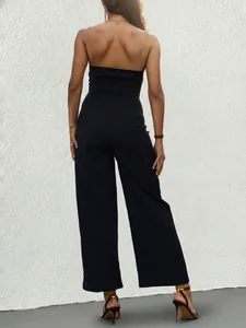 Back view of a sleek black strapless jumpsuit with high waist and hidden zipper detail