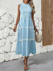 Detail of smocked bodice and lettuce trim collar on a blue striped summer maxi dress
