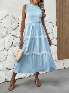 Detail of smocked bodice and blue vertical stripes on this sleeveless summer maxi dress