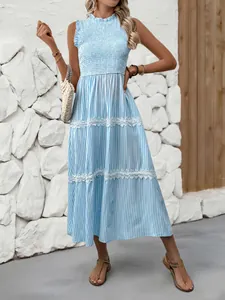 Detail of blue striped summer dress showing smocked chest and white lace trimming