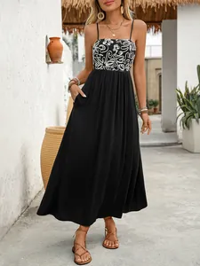 Detail of bohemian summer maxi dress with thin straps and floral embroidered bodice