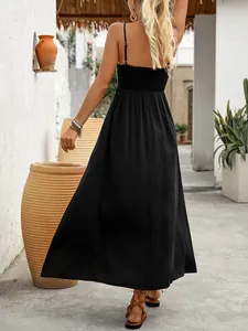 Detail of black sleeveless maxi dress with smocked back and elegant spaghetti straps