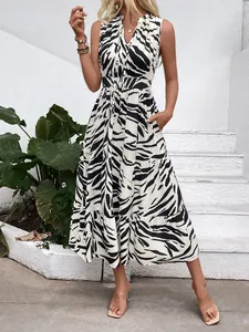 Detail of V-neck zebra print midi dress featuring elastic waist and layered ruffle skirt