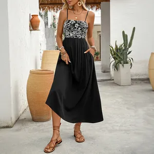 Summer sleeveless maxi dress with floral print bodice and black flowy skirt with pockets