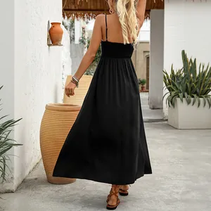 Black smocked maxi dress with sleeveless straps and flowing hem shown from the back